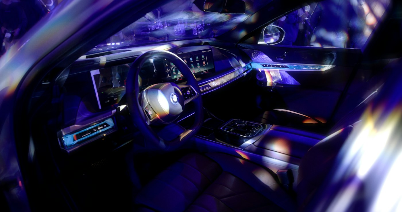 Blue and violet ambient lighting across a car dashboard and doors